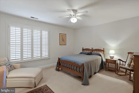 a spacious bedroom with a bed and a chandelier