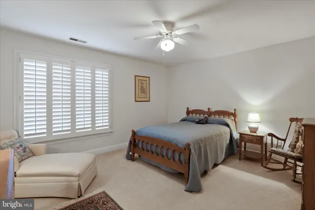 a spacious bedroom with a bed and a chandelier