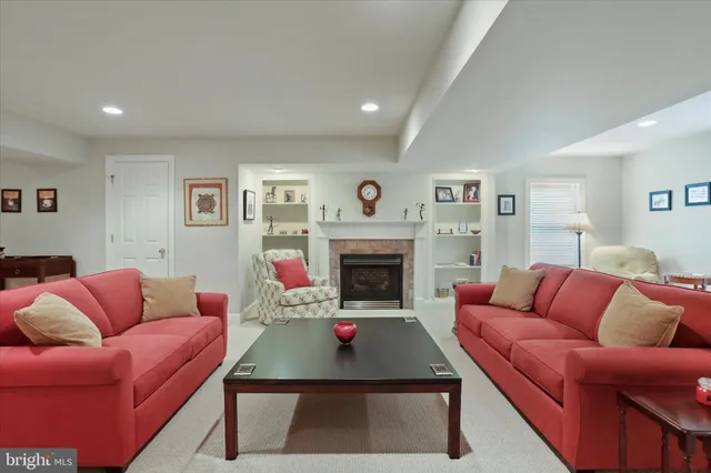 a living room with furniture a couch and a fireplace