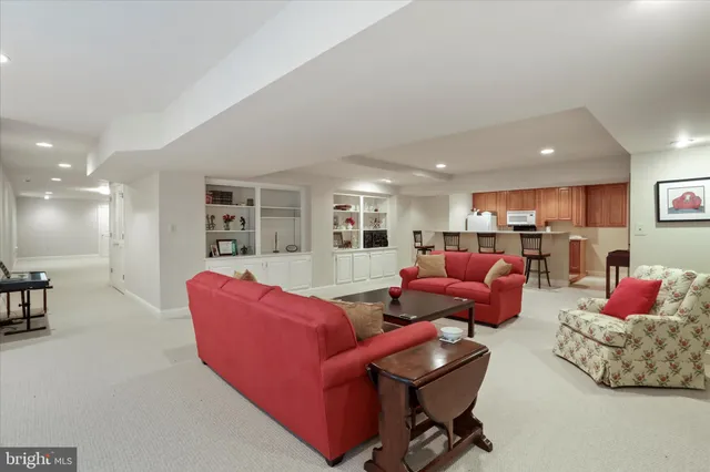 a living room with furniture kitchen and a table
