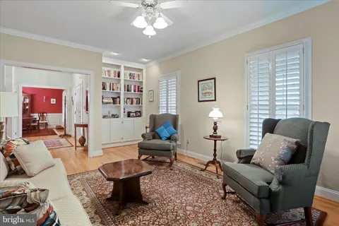 a living room with furniture a lamp and a window