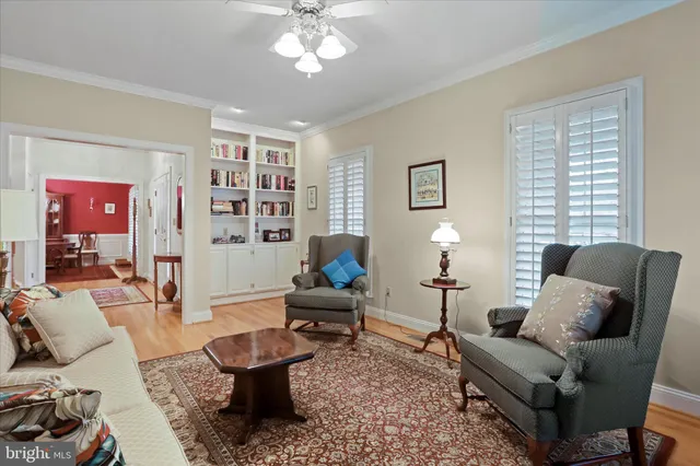 a living room with furniture a lamp and a window