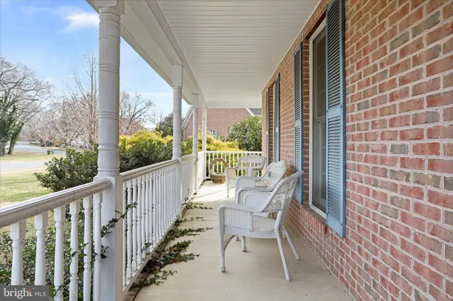 a view of a chair and tables in the balcony