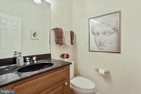 a bathroom with a sink a mirror and a toilet