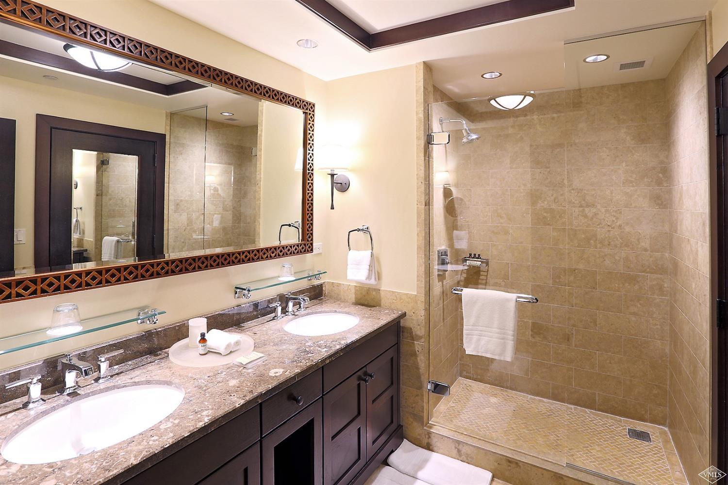 1 Vail Road, Unit 4103 Vail, CO 81657 - Photo 11 of 19 a bathroom with a granite countertop sink mirror and double