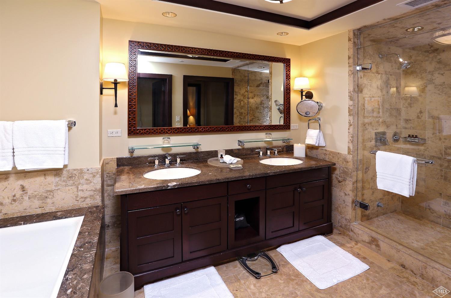 1 Vail Road, Unit 4103 Vail, CO 81657 - Photo 12 of 19 a bathroom with a granite countertop sink and a mirror
