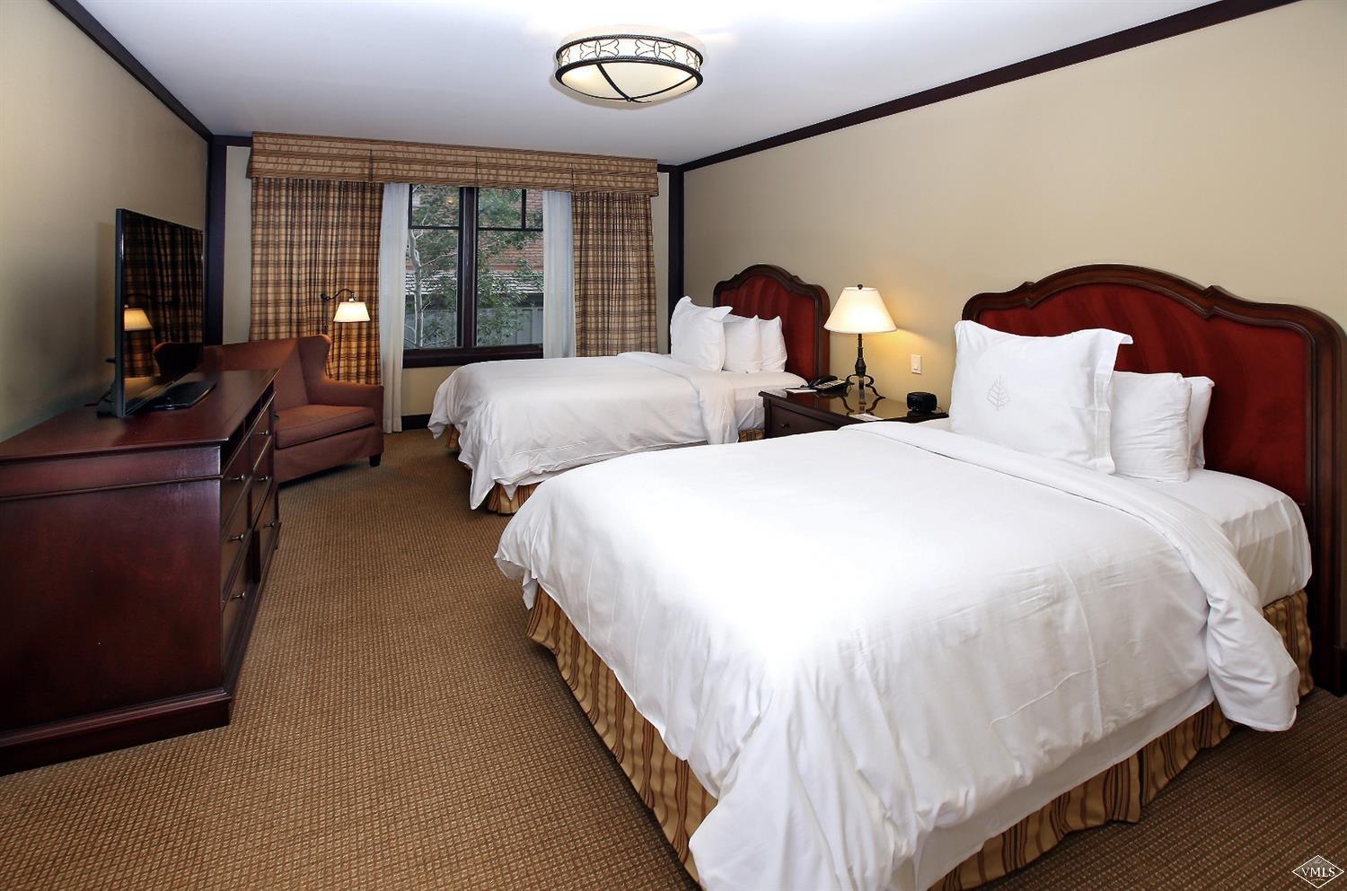 1 Vail Road, Unit 4103 Vail, CO 81657 - Photo 14 of 19 a spacious bedroom with two beds and a flat screen tv