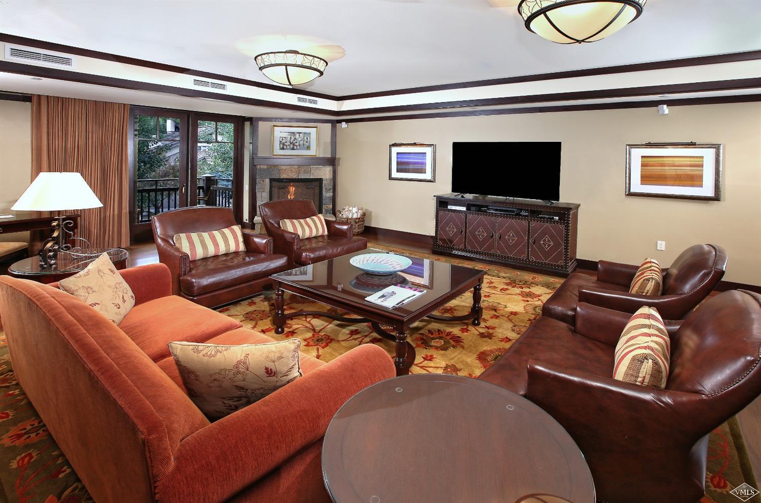 1 Vail Road, Unit 4103 Vail, CO 81657 - Photo 2 of 19 a living room with furniture a flat screen tv and a window