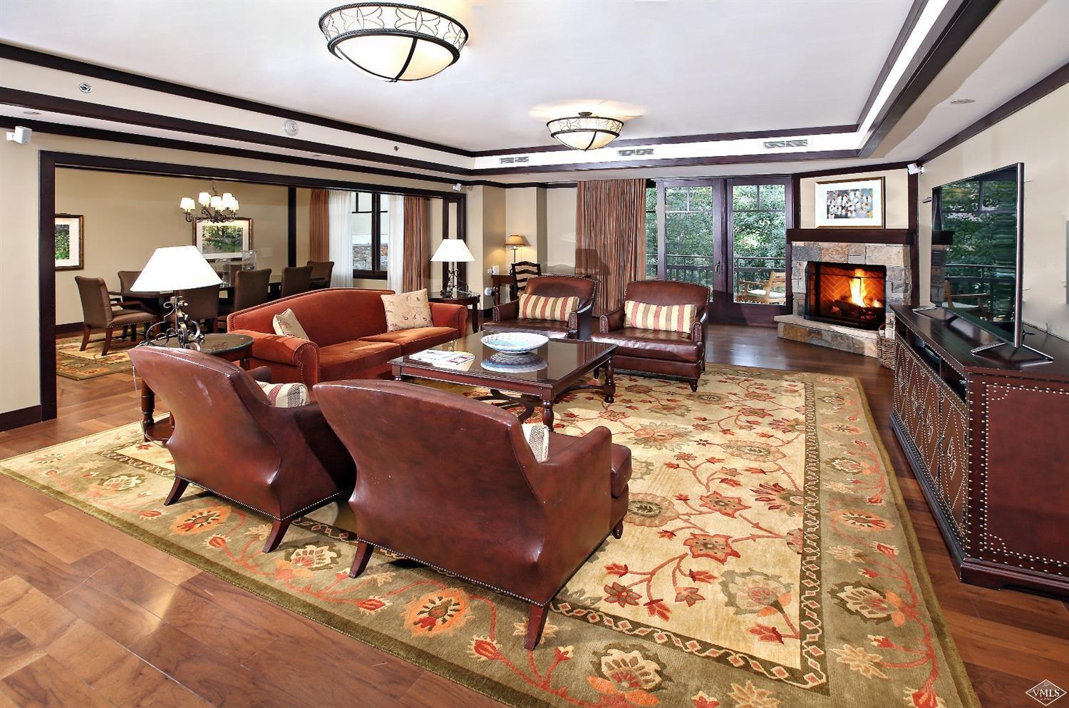 1 Vail Road, Unit 4103 Vail, CO 81657 - Photo 3 of 19 a living room with fireplace furniture and a flat screen tv