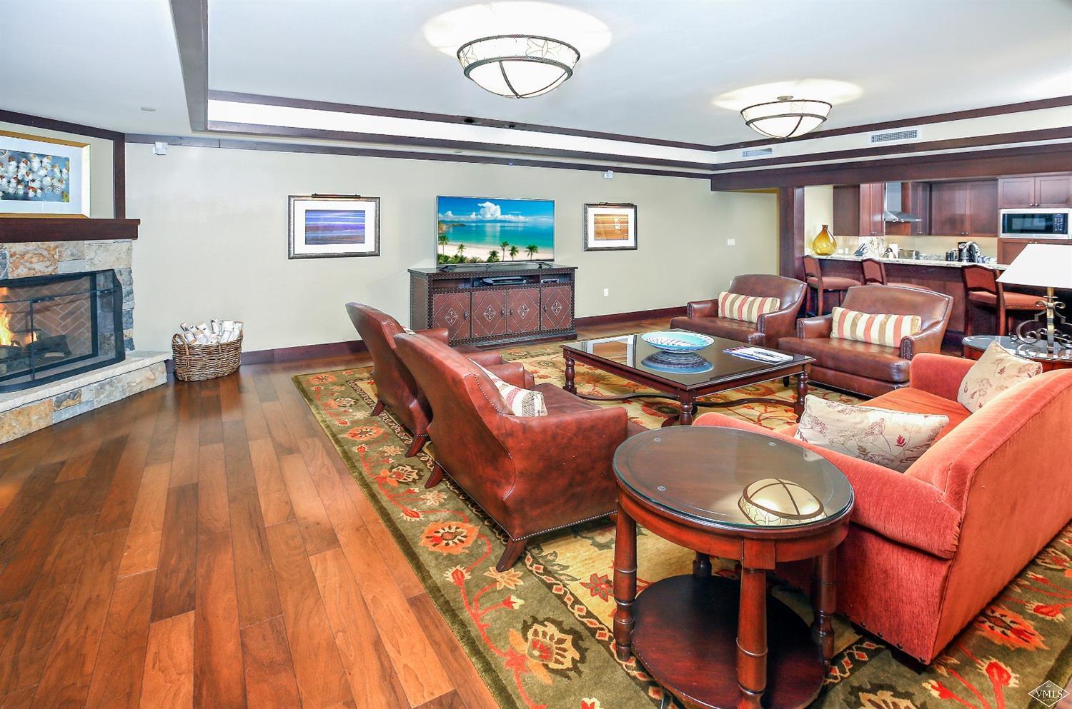 1 Vail Road, Unit 4103 Vail, CO 81657 - Photo 4 of 19 a living room with furniture and a wooden floor