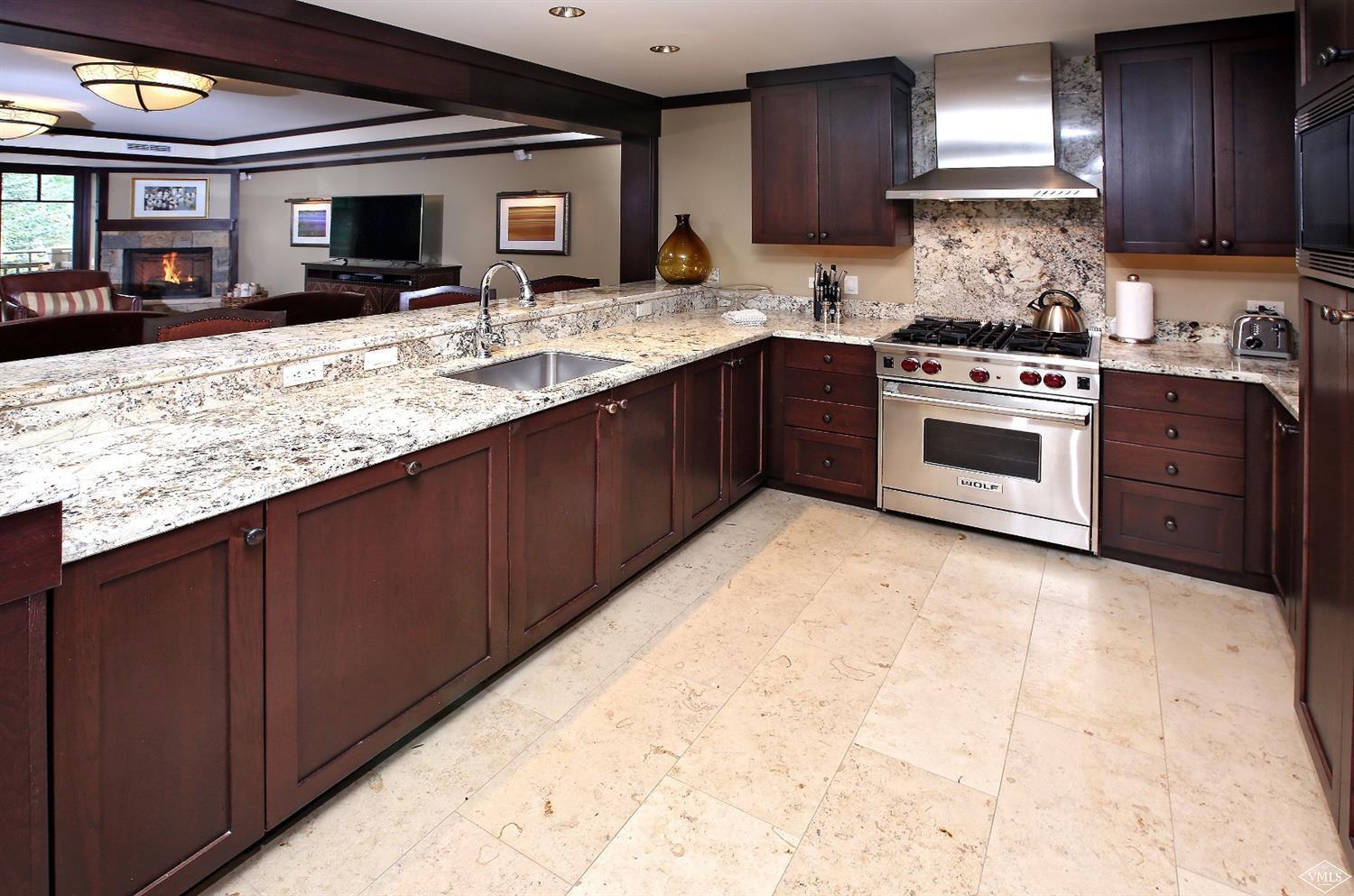 1 Vail Road, Unit 4103 Vail, CO 81657 - Photo 8 of 19 a kitchen with stainless steel appliances granite countertop a stove sink and cabinets