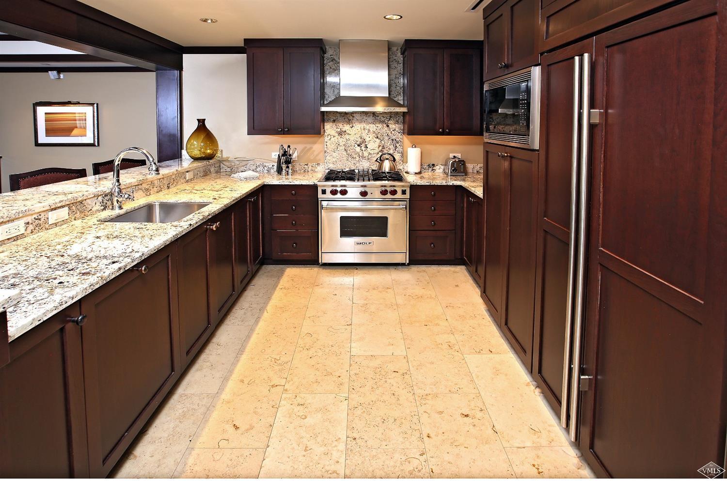 1 Vail Road, Unit 4103 Vail, CO 81657 - Photo 9 of 19 a kitchen with stainless steel appliances granite countertop a sink stove and refrigerator
