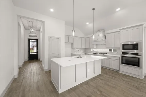 a kitchen with a sink stainless steel appliances and cabinets