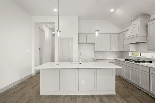 a kitchen with kitchen island white cabinets and white appliances