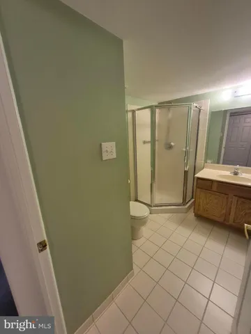 a bathroom with a glass door shower and toilet