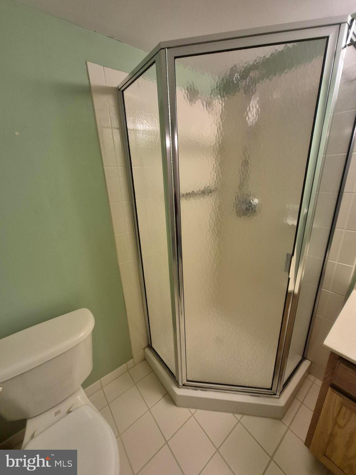 1782 Gibson Road Bensalem, PA 19020 - Photo 14 of 33 a bathroom with a glass door shower and toilet
