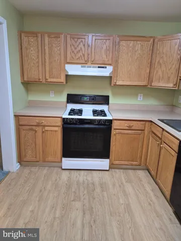 a kitchen with a sink and a refrigerator