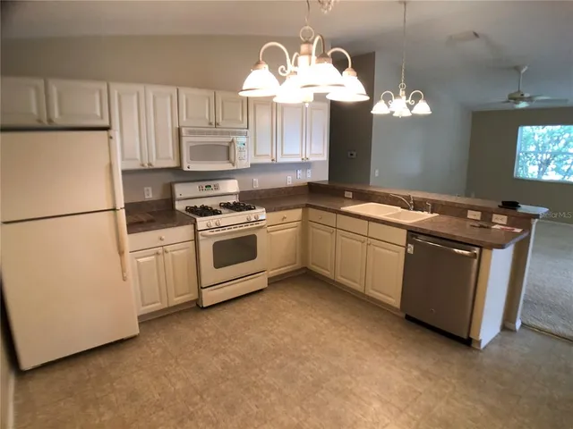 a kitchen with a sink cabinets and stainless steel appliances