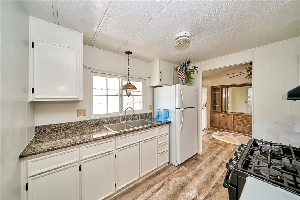 4000 Pierce Street, Unit 168 Riverside, CA 92505 - Photo 8 of 34 a kitchen with stainless steel appliances granite countertop a sink stove and refrigerator