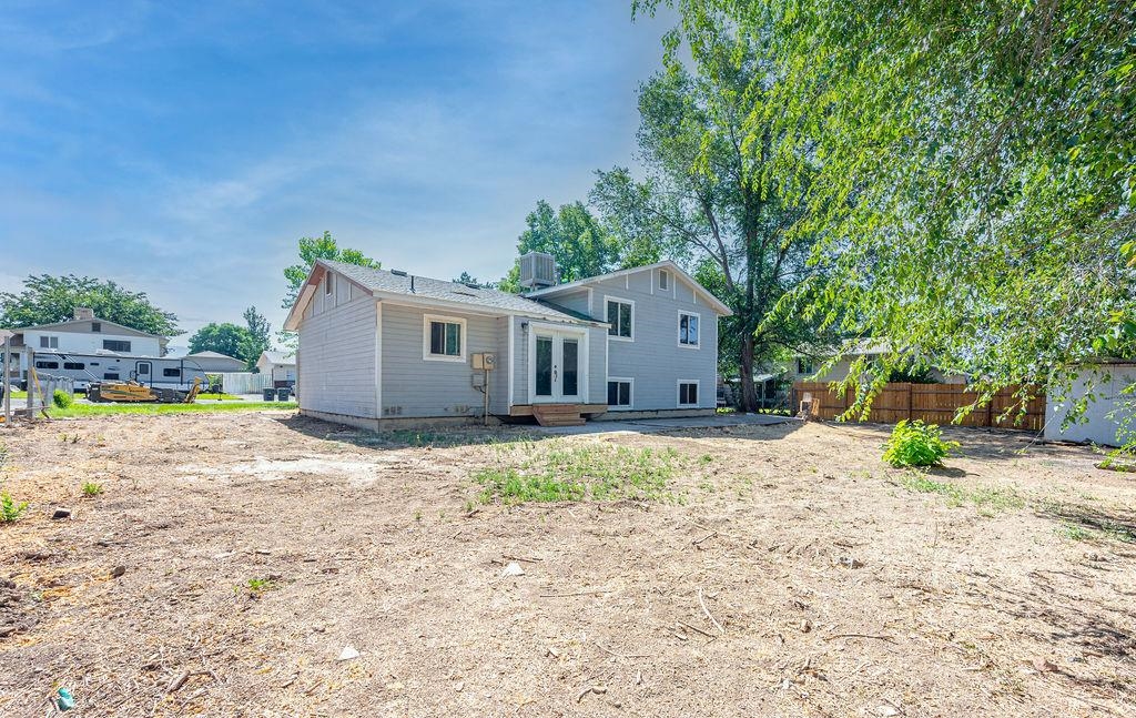631-29 29 1/4 Road Grand Junction, CO 81504 - Photo 2 of 11 a backyard of a house with potted plants and large tree