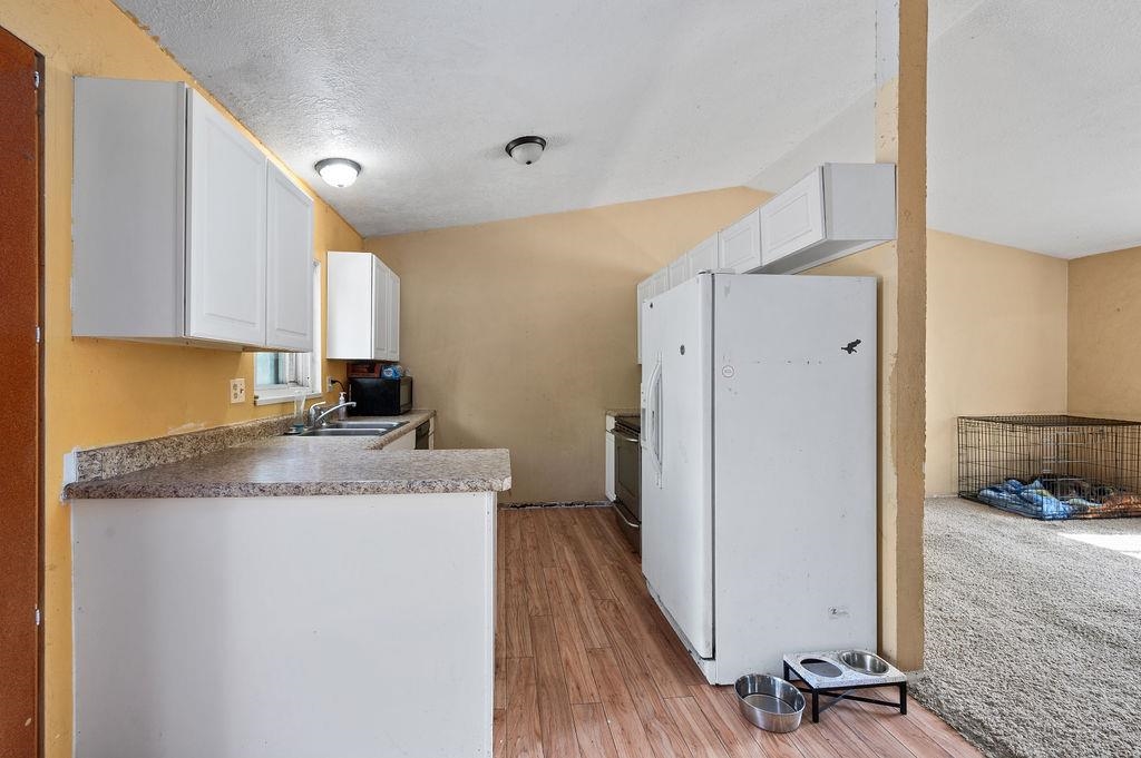 631-29 29 1/4 Road Grand Junction, CO 81504 - Photo 4 of 11 a kitchen with a granite countertop refrigerator a sink and a stove