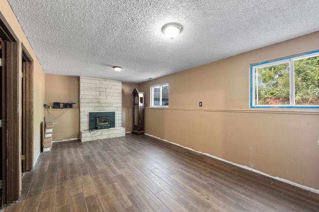631-29 29 1/4 Road Grand Junction, CO 81504 - Photo 5 of 11 an empty room with windows fireplace and wooden floor