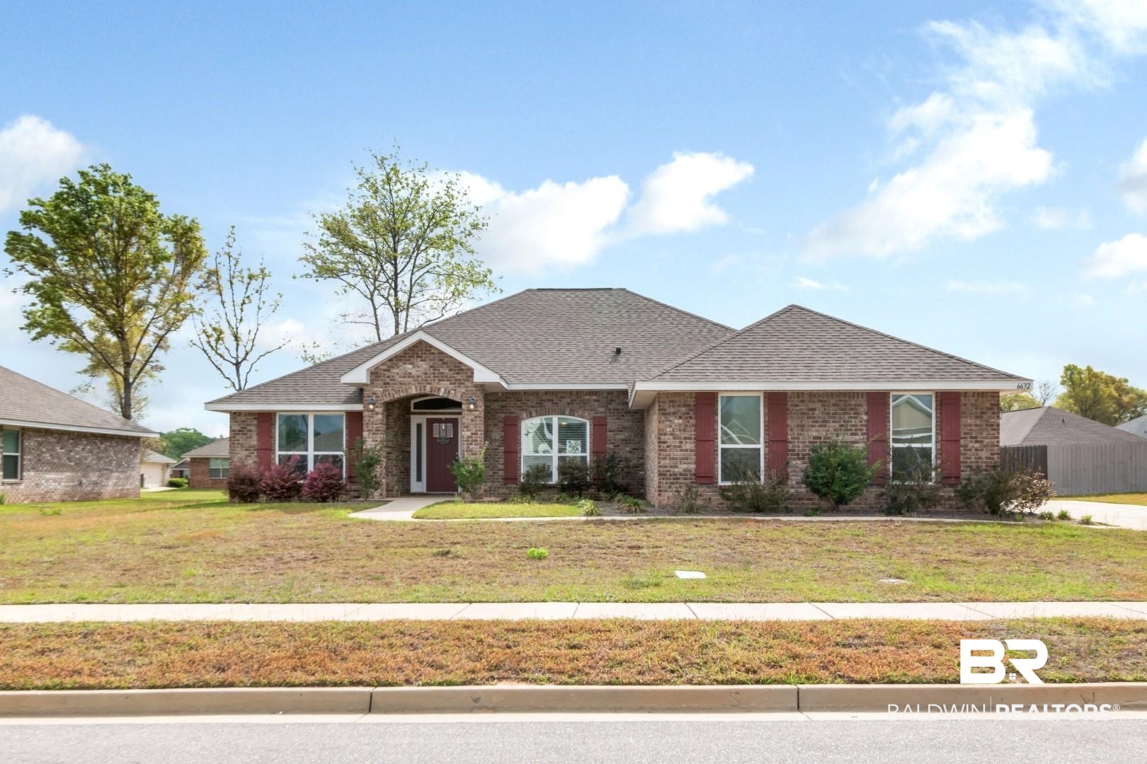 6632 Monarch Circle Mobile, AL 36618 - Photo 1 of 32 Ranch-style home with brick siding, a front yard, and a shingled roof