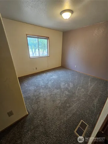 a bathroom with a sink a toilet a mirror and shower