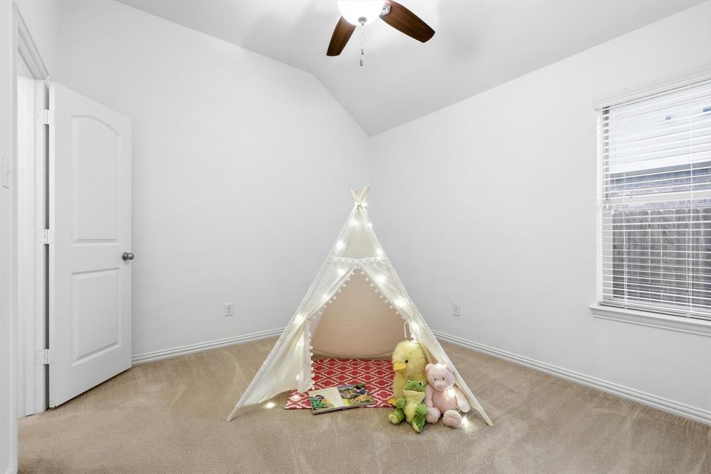 3818 Downing Drive Midlothian, TX 76065 - Photo 19 of 32 Playroom featuring ceiling fan, light colored carpet, and vaulted ceiling