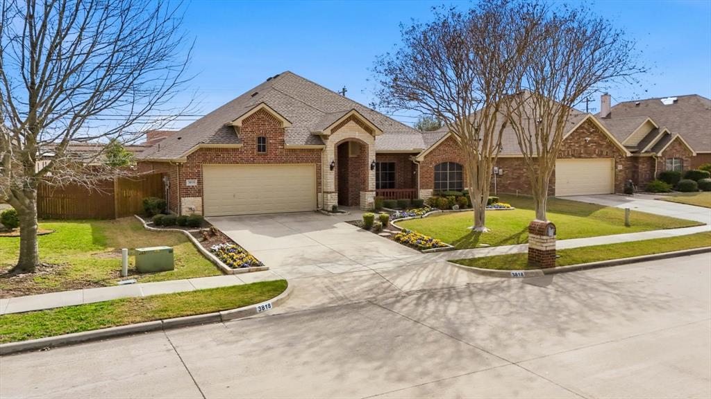 3818 Downing Drive Midlothian, TX 76065 - Photo 28 of 32 View of front of home with brick siding, a front yard, an attached garage, and driveway