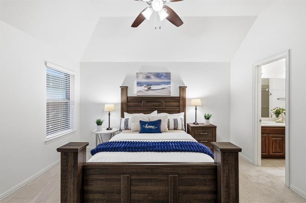 3818 Downing Drive Midlothian, TX 76065 - Photo 3 of 32 Bedroom with light carpet, lofted ceiling, a ceiling fan, and ensuite bath