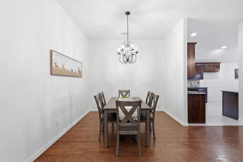 3818 Downing Drive Midlothian, TX 76065 - Photo 7 of 32 Dining area featuring dark wood-type flooring and hanging lights