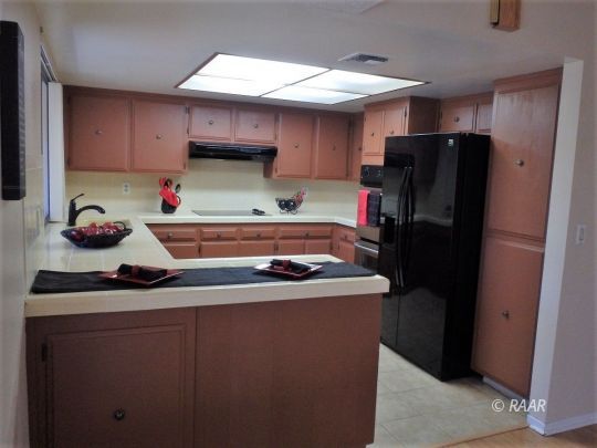 537 North Rio Bravo Street Ridgecrest, CA 93555 - Photo 18 of 35 a kitchen with stainless steel appliances granite countertop a refrigerator and a sink