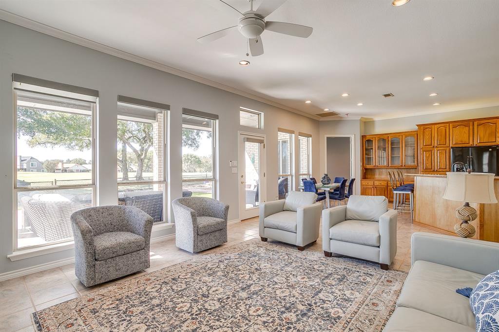 8700 Bellechase Road Granbury, TX 76049 - Photo 11 of 30 a living room with furniture and a large window