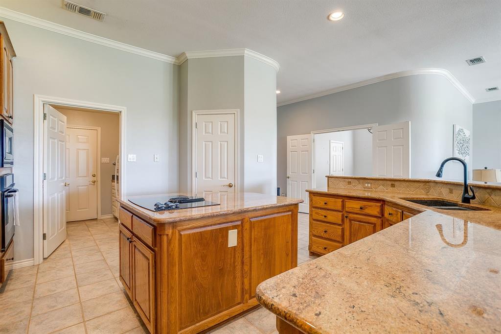 8700 Bellechase Road Granbury, TX 76049 - Photo 13 of 30 a kitchen with stainless steel appliances granite countertop a sink stove and refrigerator
