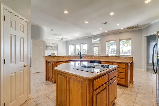 a kitchen that has a sink a stove and a refrigerator