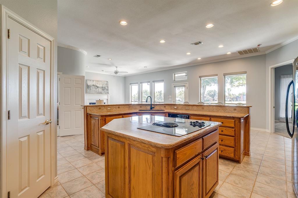 8700 Bellechase Road Granbury, TX 76049 - Photo 15 of 30 a kitchen that has a sink a stove and a refrigerator