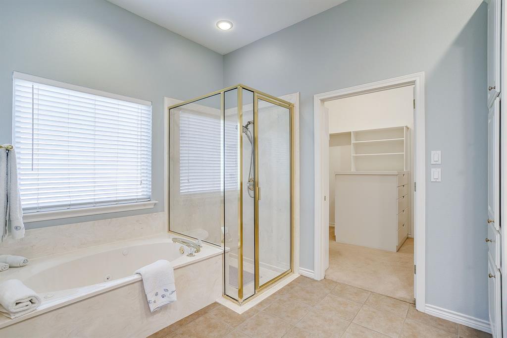 8700 Bellechase Road Granbury, TX 76049 - Photo 19 of 30 a spacious bathroom with a tub shower and a sink