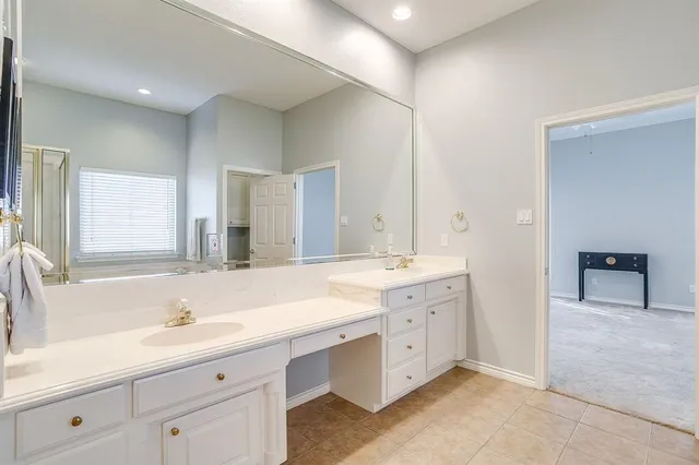a bathroom with a sink double vanity and a mirror