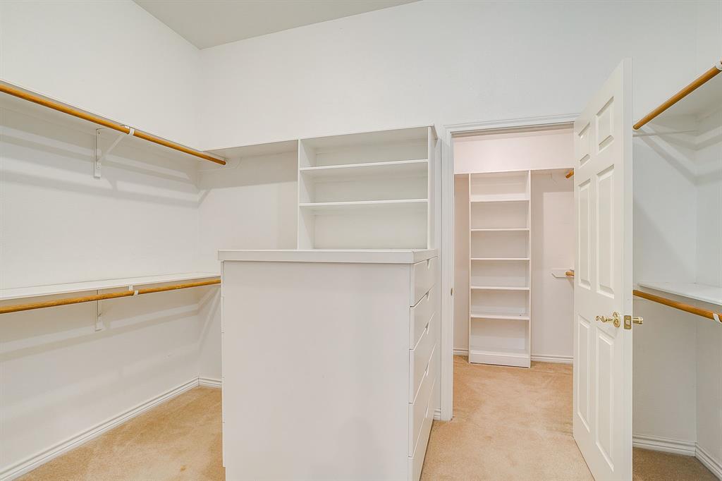 8700 Bellechase Road Granbury, TX 76049 - Photo 21 of 30 a view of walk in closet with empty racks
