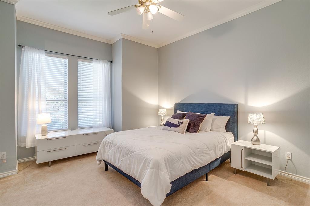 8700 Bellechase Road Granbury, TX 76049 - Photo 22 of 30 a bedroom with a bed and a chandelier