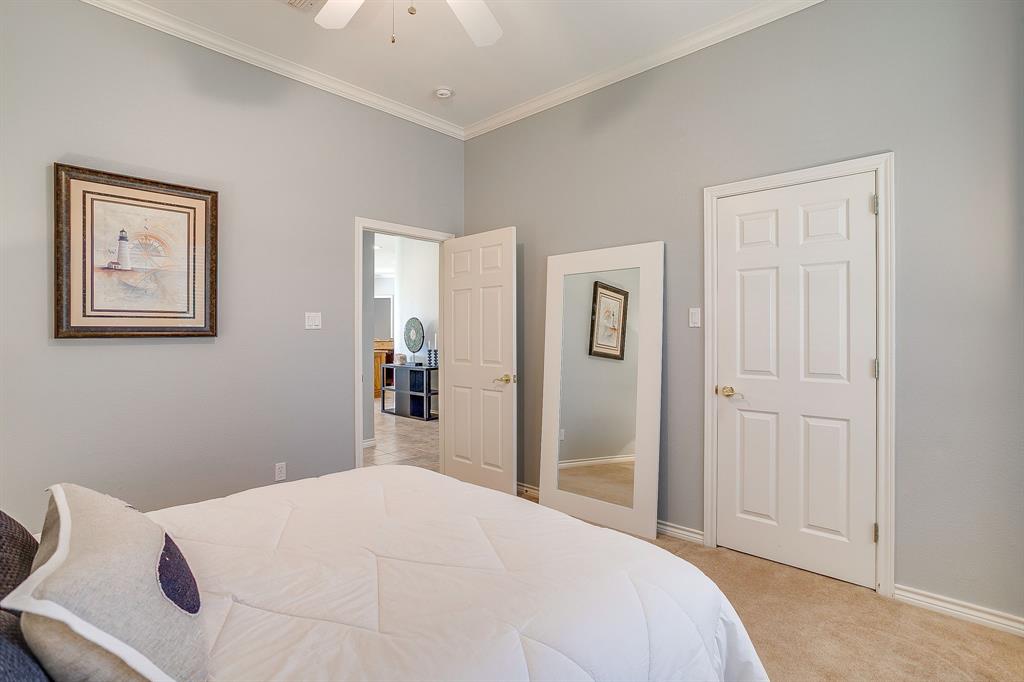 8700 Bellechase Road Granbury, TX 76049 - Photo 23 of 30 a bedroom with a bed and a painting on the wall