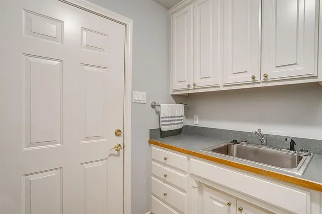 a kitchen with white cabinets and a sink