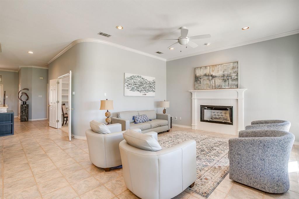 8700 Bellechase Road Granbury, TX 76049 - Photo 9 of 30 a living room with furniture and a fireplace