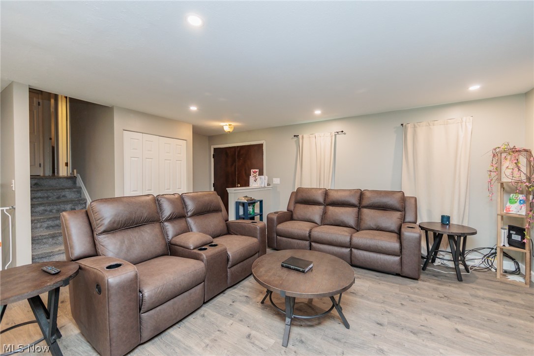 6065 Avon Belden Road North Ridgeville, OH 44039 - Photo 10 of 25 Recessed ceiling lighting, wood-finish flooring, light-toned wall paint, and white bi-fold doors