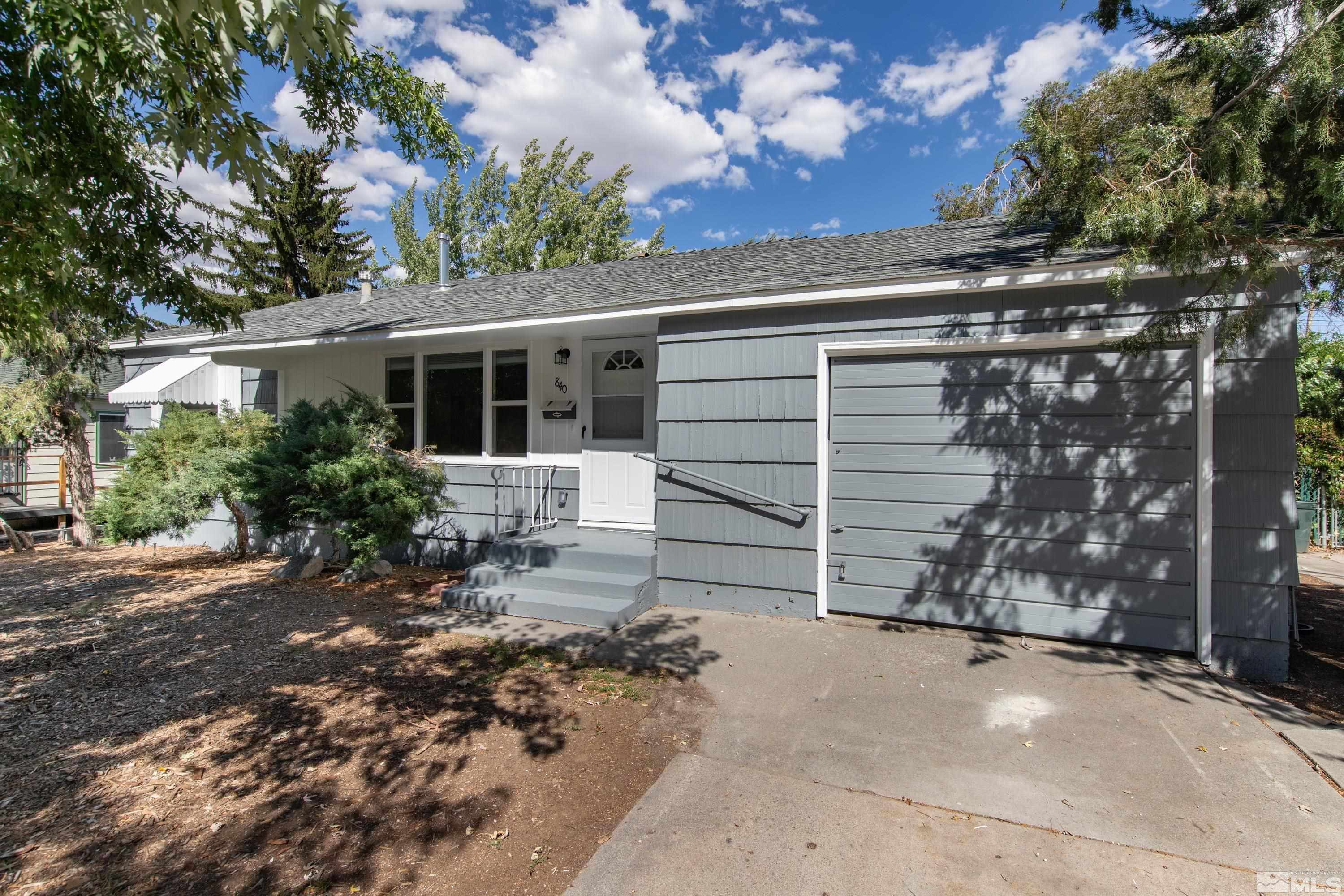 a view of house with backyard space and garden