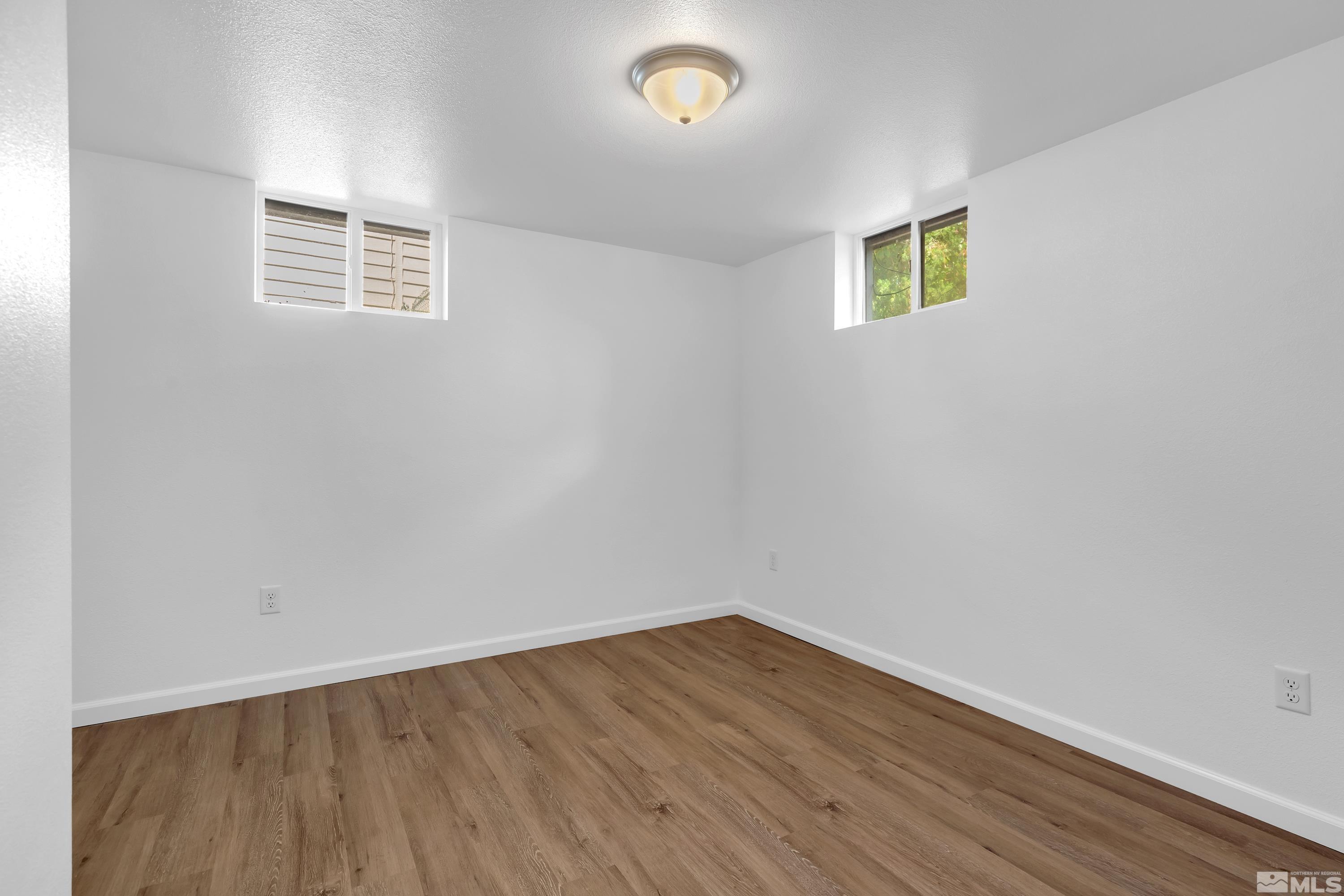840 Lodge Avenue Reno, NV 89503 - Photo 12 of 19 a view of an empty room with wooden floor and a window