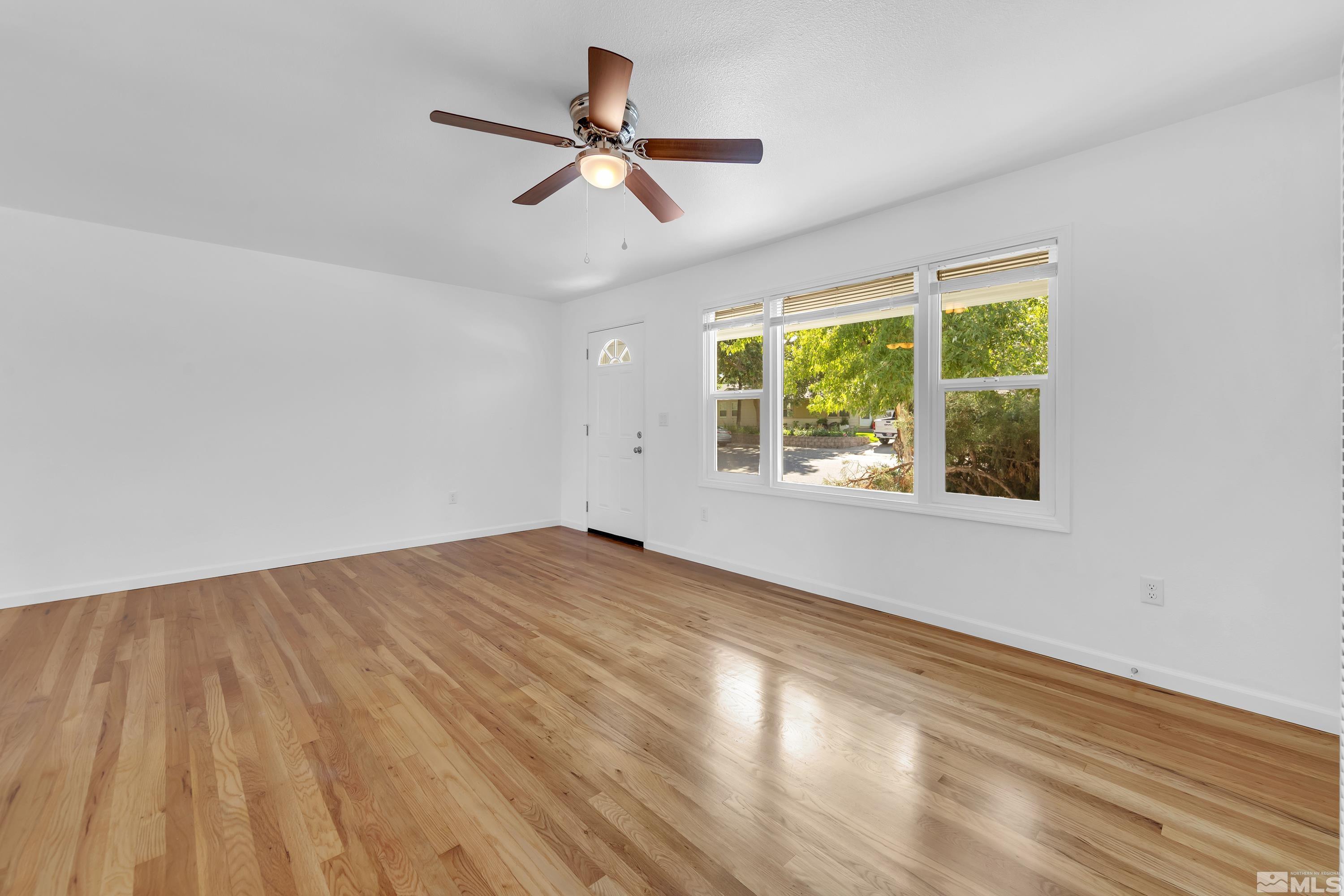 840 Lodge Avenue Reno, NV 89503 - Photo 2 of 19 a view of empty room with wooden floor and fan