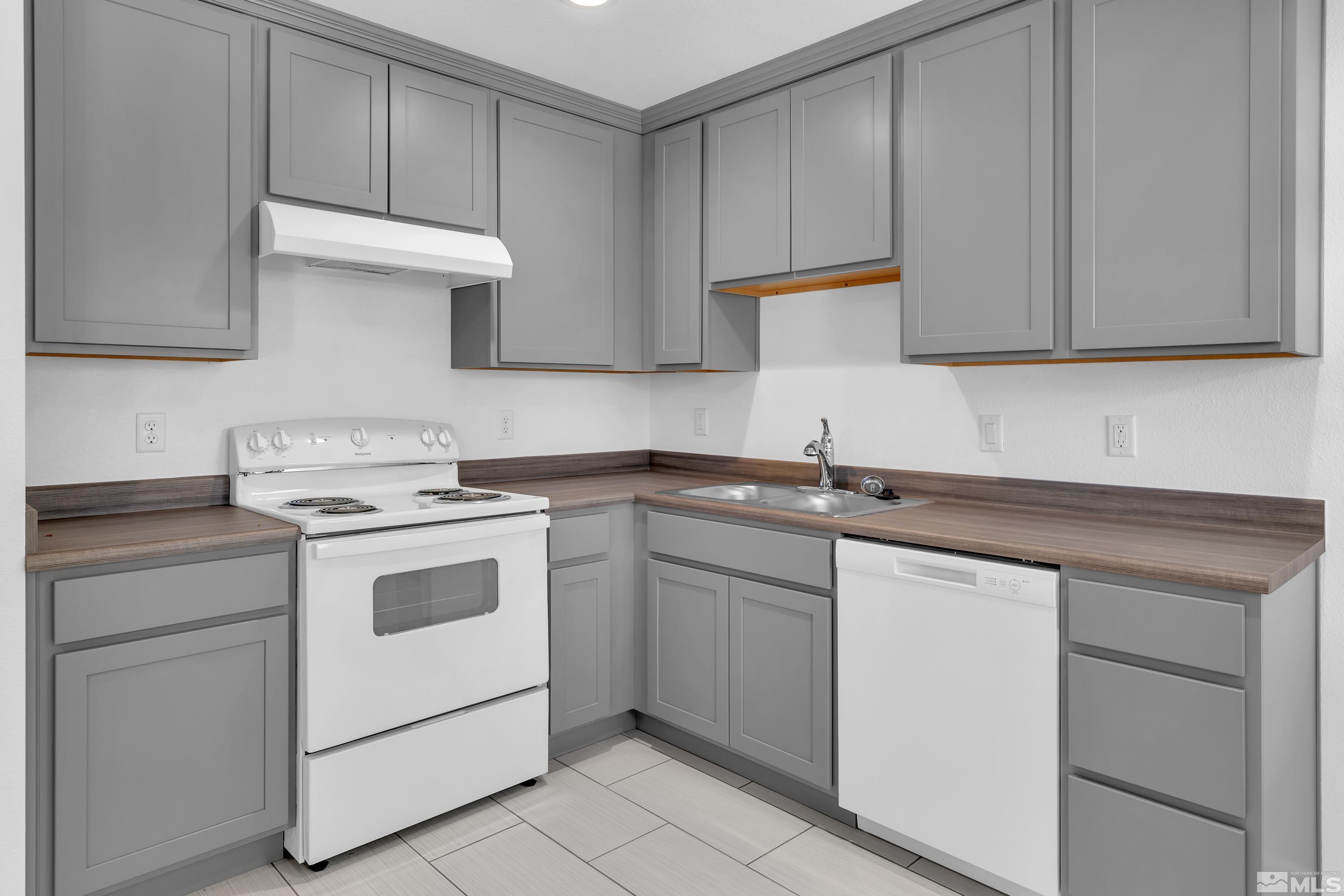 840 Lodge Avenue Reno, NV 89503 - Photo 5 of 19 a kitchen with white cabinets and white appliances