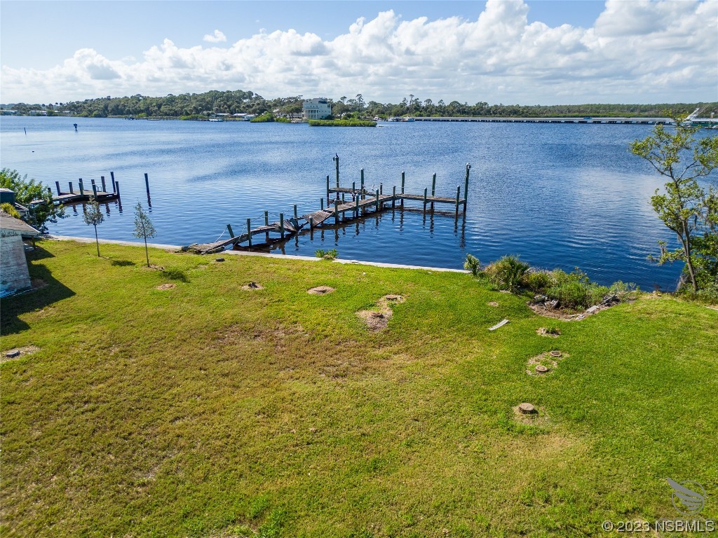 5948 Riverside Drive Port Orange, FL 32127 - Photo 23 of 27 a view of a lake with houses in the back